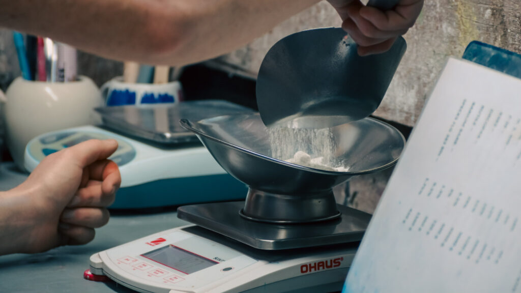 A Behind the scenes look at making glaze by weighing fine materials out.