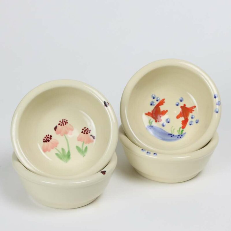 Selection of stoneware pottery Children's Bowls in multiple glazes and hand-painted designs.