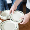 Hands holding Blueberry Classic Dinnerware and coasters. Photo by Lauren Paige Photography.