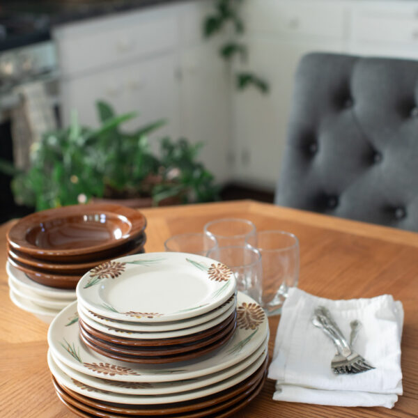 Pinecone and Copper Clay Classic Dinnerware with glasses.