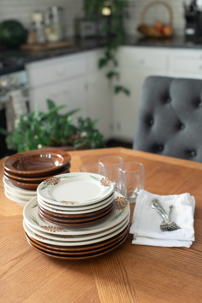 Pinecone and Copper Clay Classic Dinnerware with glasses.
